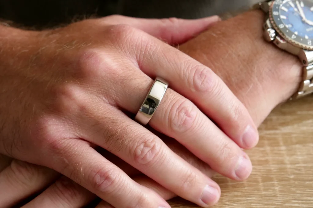 A finger-wearing Oura Ring 3  showing tracking interface with detailed metrics. 